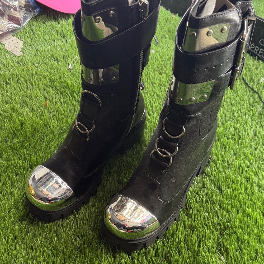 Brand new Dollskill Club Exx black with chrome plated boots.